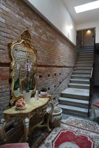 a room with a table with a mirror on a brick wall at Residence Castello Venezia in Venice