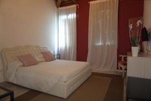 a bedroom with a white bed and a window at Residence Castello Venezia in Venice