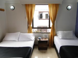 Postel nebo postele na pokoji v ubytování Hotel Esmeralda Plaza