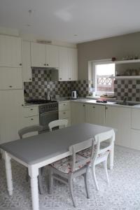 a kitchen with a table and chairs in it at dreamingzeeland in Nieuwvliet
