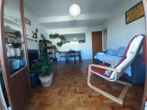 a living room with a chair and a table at Colombo & Stadium Cozy Flat in Lisbon