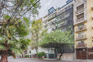 an empty street in front of a tall building at Ayenda La Joya in Mexico City