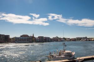 a boat is docked at a dock on a river at The Bow Hotel in Portsmouth +18 photos