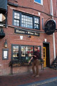 a man standing in front of a wine bar at The Bow Hotel in Portsmouth