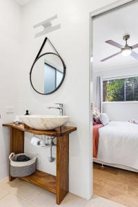 a bathroom with a sink and a mirror at Maleny Lake Cottages in Maleny