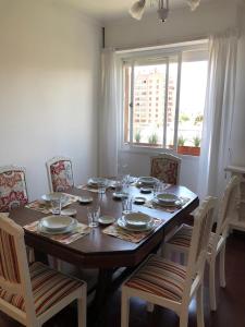 ein Esstisch mit Stühlen und ein großes Fenster in der Unterkunft El Shaddai in San Salvador de Jujuy