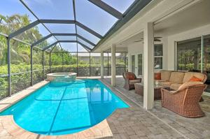 an indoor swimming pool in a house with a glass ceiling at Marco Island Home with Pool and Lanai Less Than 1 Mi To Beach in Marco Island