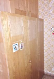 a wooden cabinet with two stickers on the side of it at Bozen Mitte in Bolzano
