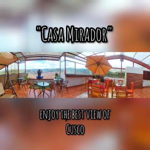 a picture of a restaurant with a table and an umbrella at Casa Mirador in Cusco