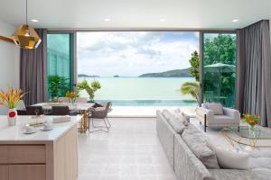a living room with a view of the ocean at Fisherman Way Beach Villa in Rawai Beach