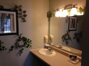 a bathroom with a sink and a mirror at Bennett Bay Inn in Coeur d'Alene