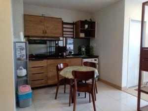 a kitchen with a table and chairs and a refrigerator at Timurbay Lavender Homestay in Kampung Sungai Karang