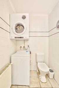 a bathroom with a toilet and a washing machine at Snow Ski Apartments 34 in Falls Creek