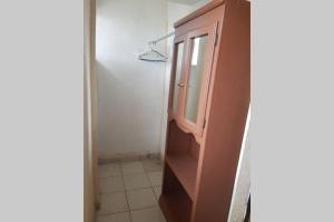 a bathroom with a wooden cabinet and a window at Departamento Ruze Rosarito Privado-Tranquilo in Plan Libertador