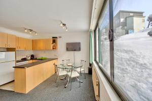 a kitchen and dining room with a table and a window at Snow Ski Apartments 05 in Falls Creek