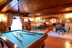 a pool table in a room with chairs and tables at Casa da Lage in Ponte de Lima