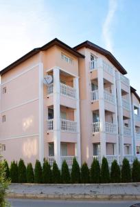a large apartment building with balconies and trees at studio ASI in Obzor