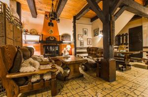 a living room with a couch and a fireplace at Karczma u Wallenroda in Ryn