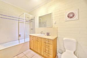 a bathroom with a toilet and a sink and a tub at Snow Ski Apartments 31 in Falls Creek