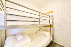 a bunk bed with two pillows in a room at Snow Ski Apartments 28 in Falls Creek