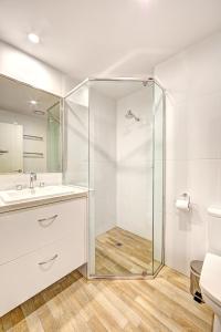 a bathroom with a glass shower and a sink at Snow Ski Apartments 39 in Falls Creek