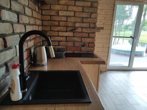 Кухня или мини-кухня в Poilsio namas Vydautiškių slėnis
 +31 фотография