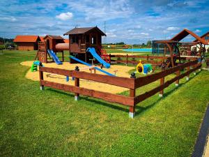 a park with a playground with slides and a play structure at Hotel Wellness & SPA Antyczny Dwór in Rudna Mała