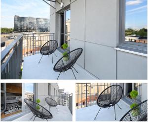 a black chair on a balcony with a window at Przestronny, przytulny apartament w sercu Łodzi in Łódź