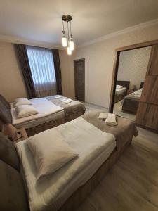 A bed or beds in a room at Kazbegi Guide