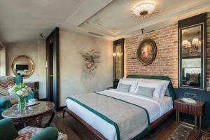 a bedroom with a bed and a brick wall at Tria Hotel Istanbul-Special Category in Istanbul