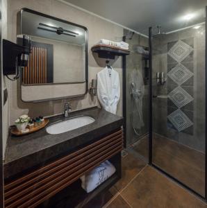 a bathroom with a sink and a shower at Tria Hotel Istanbul-Special Category in Istanbul