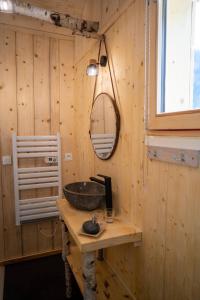 a bathroom with a sink in a wooden wall at Le Chalet Du Blanc Spa yoga in Aillon-le-Jeune +51 photos