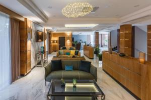 a lobby of a hotel with couches and a table at ATECA Hotel Suites Tashkent in Tashkent