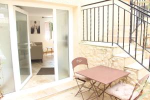 a room with a table and chairs and a staircase at Appartement PERIGUEUX Garage Fibre Climatisation in Périgueux