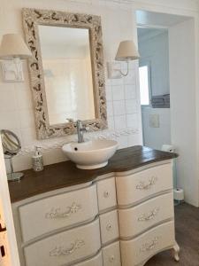 a bathroom with a sink and a mirror on a dresser at Villa La Croisée des Chemins in Bray-Dunes +35 photos