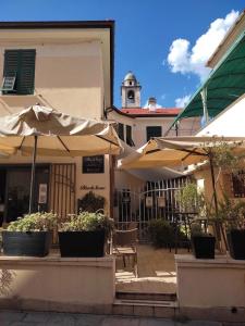 un patio avec des parasols devant un bâtiment dans l'établissement Blackstone Apartment, à Varazze