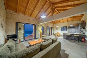 a living room with a couch and a table at Kaminia Blu in Ratzaklíon