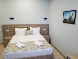 Uma cama ou camas num quarto em Vita Gardenia Hotel Tskaltubo