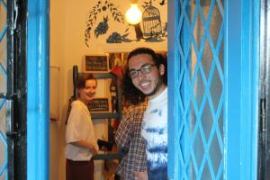 a man and a woman standing in a doorway at Battuta Hostel in Amman