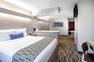 a hotel room with a large bed and a kitchen at Microtel Inn & Suites by Wyndham Atlanta Buckhead Area in Atlanta