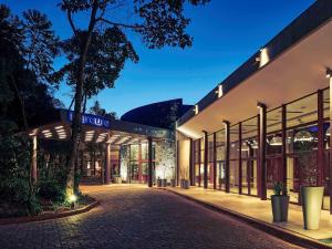 a building with a street in front of it at Mercure Iguazu Hotel Iru in Puerto Iguazú