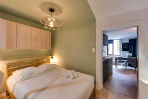 a bedroom with a bed and a dining room at L'Atelier Filaterie - Apartment for 2 people in Annecy