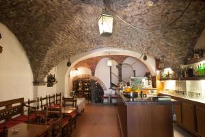 a bar in a restaurant with a stone ceiling at Hotel Splendid Mare in Laigueglia