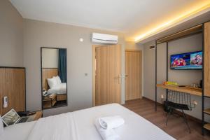 um quarto de hotel com uma cama e uma televisão em Çorlu Dem Hotel em Çorlu