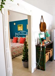 a bedroom with a bed and a blue wall at Casa Levante in Canosa di Puglia
