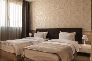 Letto o letti in una camera di IG Hotel