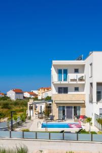 a view of a building with a swimming pool at Villa Buzuk in Vodice