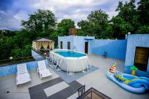 a patio with a pool and a hot tub at Hotel Balcony in Kutaisi