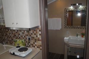 a bathroom with a toilet on a counter next to a sink at Amaryllis Studios in Asprovalta +13 photos