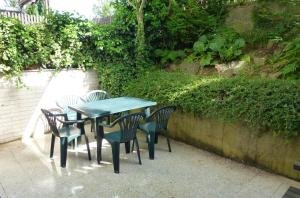 a table and four chairs sitting next to a wall at Ubytování v soukromí Luhačovice - Pozlovice in Luhačovice